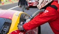 Mechanic refuelling car Ferrari 488 GT during race pit stop