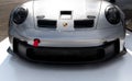 Porsche car front hood close up logo on shiny silver luxury car