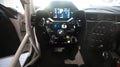 Race steering wheel close up driver point of view, BMW logo buttons and