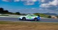 Spectacular touring race car on asphalt track speed with motion blurred
