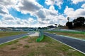 Touring race car on circuit track agains blue sky and clouds, BMW M2