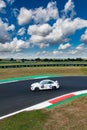 Touring race car on track agains blue sky and clouds, BMW M2 motor sport