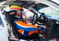 Touring racing car driver sitting in car cockpit ready for race