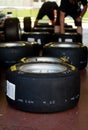 Close up of Pirelli P zero racing tire in paddock, large group set of tires defocused