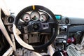 Racing car driver point of view in empty cockpit, steering wheel and dashboard