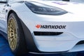 Close up of Hankook racing tire with logo mounted on Tesla electric car