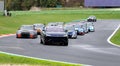 Group of touring cars during race formation lap headed by safety car Royalty Free Stock Photo