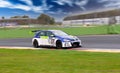 Volkswagen golf TCR touring race car in action on racetrack blurred background