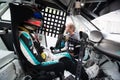 Touring car driver with helmet and suit sitting in cockpit Royalty Free Stock Photo