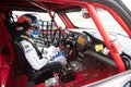Touring car Mini Cooper driver with helmet and suit sitting in cockpit Royalty Free Stock Photo