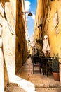 Alley and small tables in the shade Royalty Free Stock Photo