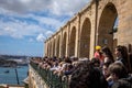 Crowd of tourists on the balcony at Upper Barakka Gardens, Saluting Battery canon firing ceremony in Valletta, Malta. .