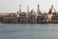 Valletta, Malta, August 2015.Kind of the ancient city and modern port cranes.
