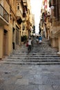 Valletta, Malta, August 2015. Tourists on one of the medieval streets.