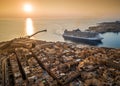 Valletta, Malta - Huge cruise ship entering the Grand Harbor of Valletta at sunset