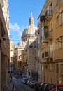 VALLETTA, MALTA - NOVEMBER 10TH 2019: A cargo vessel sails round the Tigne Point in Malta, about to enter the docks at Valletta