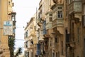 Residential limestone houses with traditional wooden balconies in Valetta, Malta