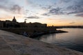 Cityscape of Valletta, Malta during the sunset and early dusk with dark sky and silhouette of the city