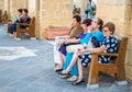 Valletta, Malta, October 14, 2017: Portrait of an attractive elegant senior women are sitting on the bench in terrace