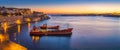 Valletta, Malta - Panoramic skyline view of Valletta and the Grand Harbor on a beautiful summer morning minutes before sunrise wi