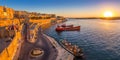 Valletta, Malta - Panoramic skyline view of Valletta and the Grand Harbor with beautiful sunrise, ships