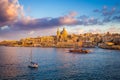 Valletta, Malta - Sail boats at the walls of Valletta with Saint Paul`s Cathedral and beautiful sky and clouds Royalty Free Stock Photo