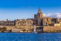 Valletta, Malta - Saint Paul`s Cathedral and the ancient walls of Valletta with sail boat