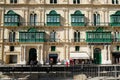 Vallettta, Mlata, 05/02/2020 Typical maltese architecture - house made of limestone with green wooden balconies