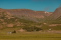 Valley close to Haganes ICeland with crystal clear blue water and some hills and country farms in the background