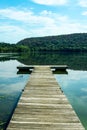 Vertical view of the wooden boat pier on the peaceful Rockland Lake in New York State`s