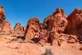 Valley of Fire - Couple at the entrance of windstone arch (fire cave) in Valley of Fire State Park, Mojave desert, Nevada, USA