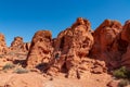 Valley of Fire - Man at exterior entrance of windstone arch (fire cave) in Valley of Fire State Park, Mojave desert, Nevada, USA