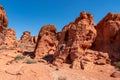 Valley of Fire - Man at exterior entrance of windstone arch (fire cave) in Valley of Fire State Park, Mojave desert, Nevada, USA