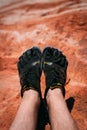 Valley of Fire, Nevada, USA - October 6, 2019: Detail on a person wearing Vibram Five Finger hiking shoes at Fire wave, USA