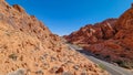 Valley of Fire - Panoramic view of endless winding empty Mouse tank road through canyons of red Aztec Sandstone Rock Royalty Free Stock Photo