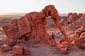 Valley of Fire - Tourist woman standing next to elephant shaped Aztec Sandstone Rock formations during sunrise, Nevada Royalty Free Stock Photo