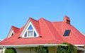 Valley and gable roofing construction with attic windows, rain gutter, waterproofing. Roof gutter system, skylight window on attic