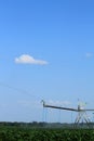 A Valley Irrigation system watering a farm field with green corn Royalty Free Stock Photo