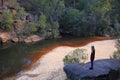 River bank valley Australian landscape with woman standing on boulder Royalty Free Stock Photo