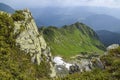 Valley among majestic rugged mountain hills and peaks covered in green lush grass Carpathian mountains Royalty Free Stock Photo