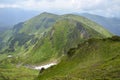 Valley among majestic rugged mountain hills and peaks covered in green lush grass Carpathian mountains Royalty Free Stock Photo