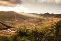 Valley in the mountains with small village. Mountain landscape with palm trees during sunset. Tenerife, Canary Islands Royalty Free Stock Photo