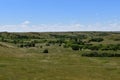 Valley prairie scene with a cemetery