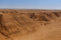 Valley of sandstone rocks on the horizon of the Sahara desert of Tunisia Royalty Free Stock Photo