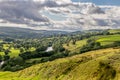 A valley with sheep and rain clouds