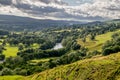 A valley with sheep and rain clouds