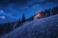 Valley with shepherd`s wooden house at night