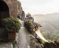 Valley view in the mist from the mountainous street in the medieval commune town of Calcata in Italy