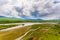 Valley view with river and mountains in the background at sunrise Royalty Free Stock Photo