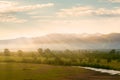 Valley view with river and mountains in the background at sunrise Royalty Free Stock Photo